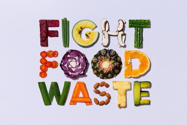 An illustration of the phrase "Fight Food Waste" with different parts of fruits and vegetables